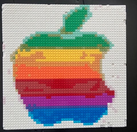 A real, finished brick mosaic of a rainbow apple logo built from 1x1 bricks